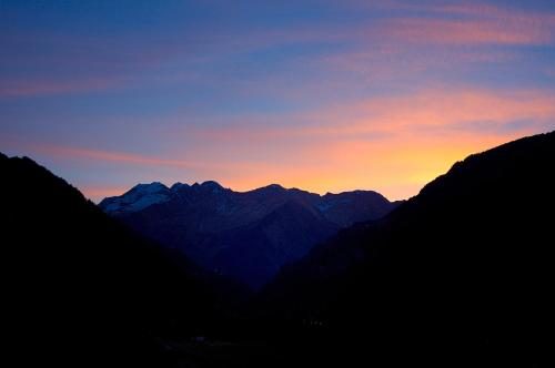 a view of a mountain range at sunset at Pension Alpenhof in San Leonardo in Passiria