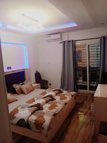 Katil atau katil-katil dalam bilik di Cozy Appartement Dakar