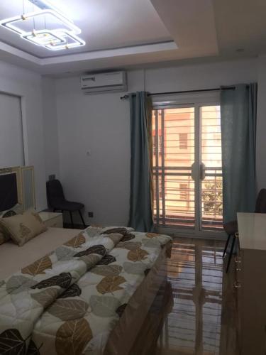 Katil atau katil-katil dalam bilik di Cozy Appartement Dakar
