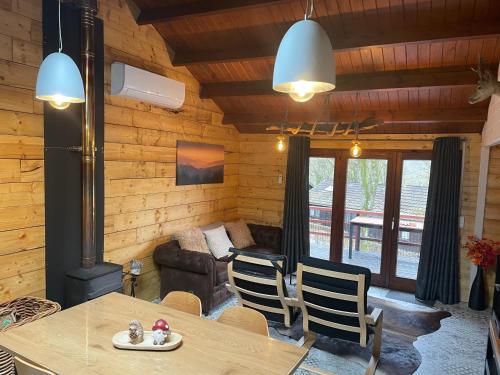 a living room with a table and a couch at Chalet 9 La Boverie in Rendeux