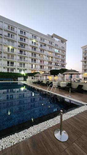a large building with a swimming pool in front of a building at ARMERIA STAY DLF MYPAD-512 in Lucknow