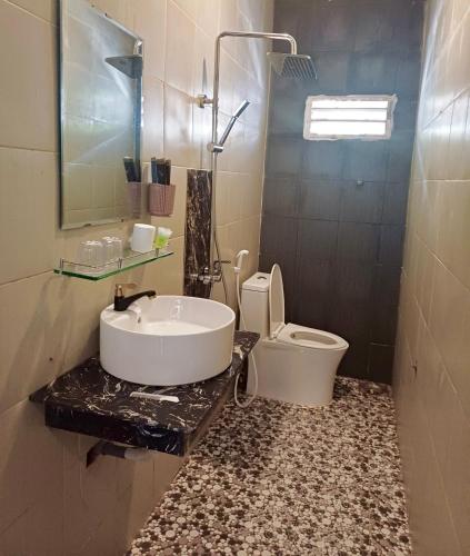 a bathroom with a sink and a toilet at Maria Hotel in Ba Tri