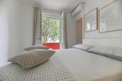a bedroom with a bed with two pillows on it at Near old town apartment with free parking and air condition in each room in Zadar