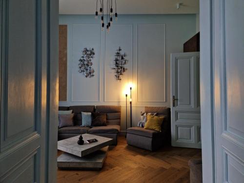 a living room with a couch and a table at Victory Apartment in Timişoara