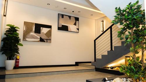 a staircase in a house with art on the walls at STeam Residence102# in Riyadh