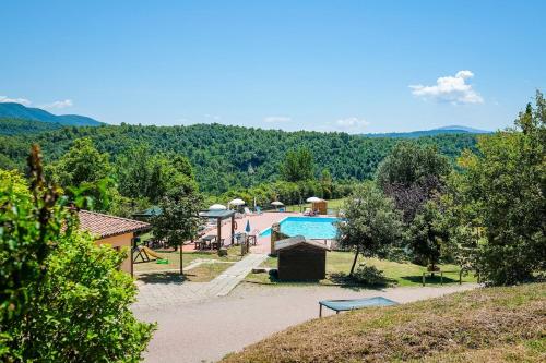 a resort with a swimming pool and a playground at Agriturismo Casal Cerqueto in Canalicchio