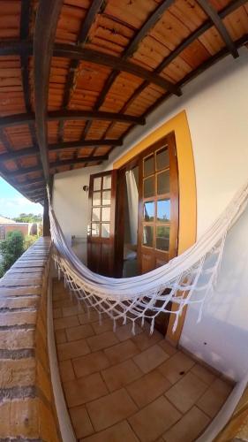 a hammock on a porch of a house at Hotel Natur Campeche in Florianópolis