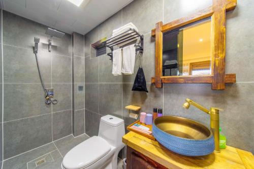 a bathroom with a sink and a toilet at GeGeHouse - Lijiang Old Town in Lijiang