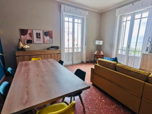 a living room with a table and a couch at Sun&Sea Apartment in Lido di Ostia