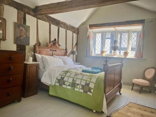 a bedroom with a large bed and a window at Hastings Old Town. Cottage - by the sea in Hastings