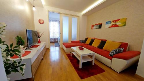 a living room with a couch and a table at Delta Residence Belville in Belgrade