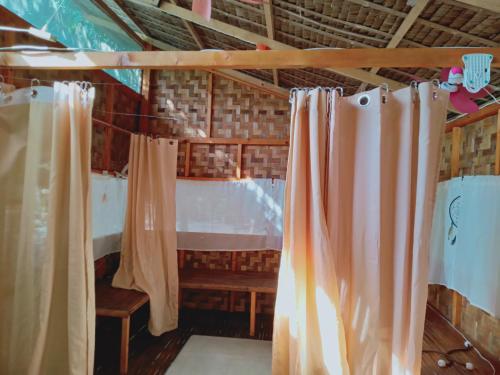 a room with curtains and a table and a bench at Wellness & Fitness In Life La Union Postural & Joint Alignment Yoga Retreat Yoga Session Center 