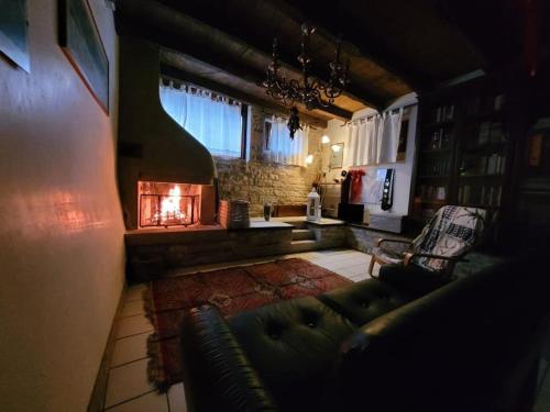 a living room with a couch and a fireplace at Casa Desi in Combai