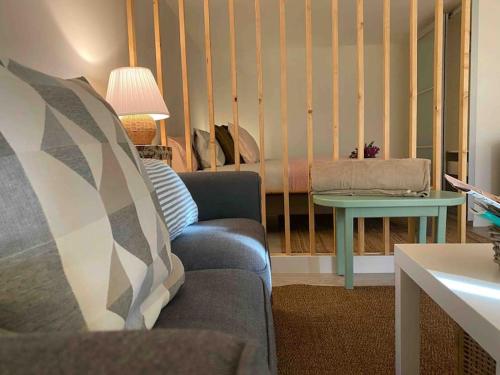 a living room with a couch and a table at Vivienda vacacional el grillo feliz in Tegueste