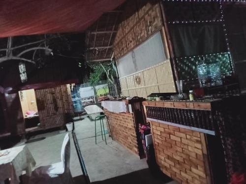 a restaurant with a bar with tables and chairs at SECLUDED GLAMPING YOGA SAMADHI fan 2 kubos 8 pax in Rimus