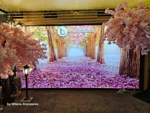 a painting of a tunnel of pink flowers at Lucky Bansko Aparthotel SPA & Relax in Bansko