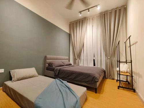 a bedroom with two beds and a window at LV13 PoolView Kuantan by Vhomestay in Kuantan