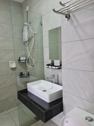 a bathroom with a sink and a shower at Sky Tree Studio Apartment at Bukit Indah, Johor in Johor Bahru
