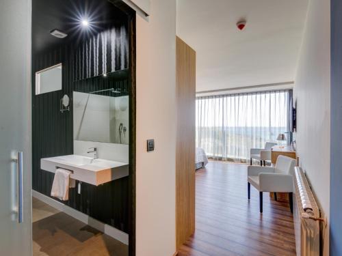 
a bathroom with a sink, toilet, and mirror at Hotel Astuy in Isla
