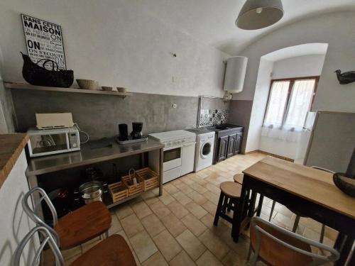 a kitchen with a table and a dining room at Appartement centre Saint Florent in Saint-Florent