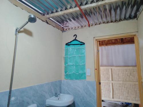 a bathroom with a toilet and a sink and a lamp at SECLUDED GLAMPING YOGA SAMADHI fan 2 kubos 8 pax in Rimus