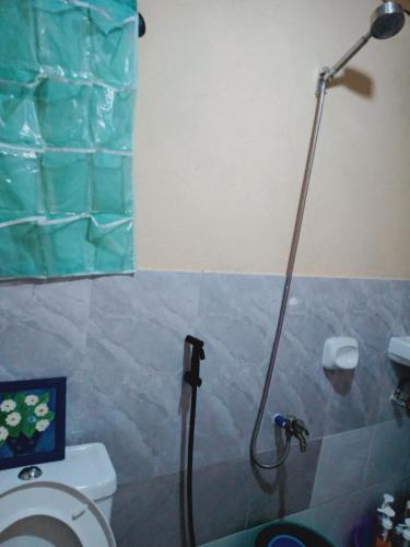 a shower in a bathroom with a toilet at SECLUDED GLAMPING YOGA SAMADHI fan 2 kubos 8 pax in Rimus