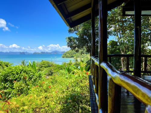 a room with a view of the water at Hillhouse - Koh Yao Noi in Ko Yao Noi