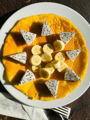 a plate with a pancake with sliced bananas on it at Hillhouse - Koh Yao Noi in Ko Yao Noi