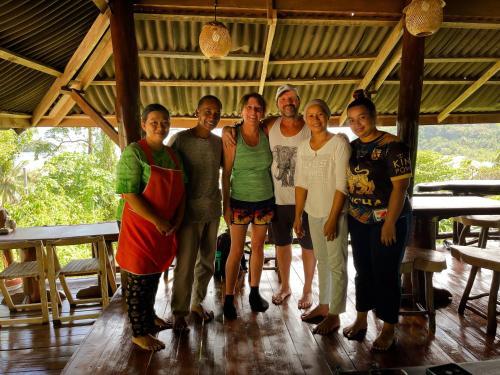 a group of people posing for a picture on a porch at Hillhouse - Koh Yao Noi in Ko Yao Noi