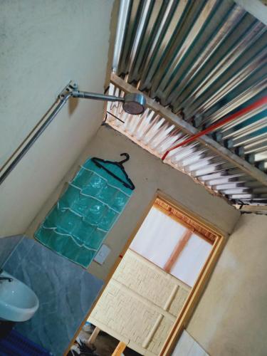 an attic room with a window and a light fixture at SECLUDED GLAMPING YOGA SAMADHI fan 2 kubos 8 pax in Rimus