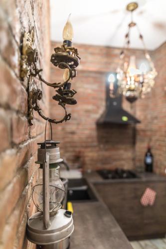a kitchen with a glass bottle attached to a wall at Loft Style Apartment in Tbilisi City