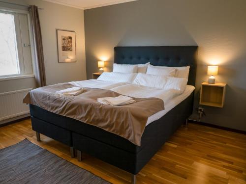 a large bed in a bedroom with two towels on it at Spångens Gästgivaregård in Ljungbyhed