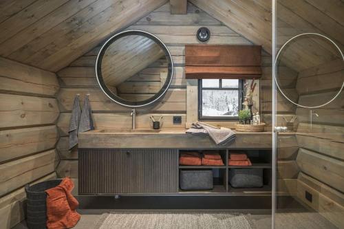 a bathroom with a sink and a mirror at Hyttekos Lodge: luxury ski-in/ski-out chalet in Kvitfjell