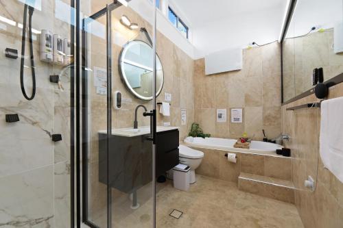a bathroom with a toilet and a sink and a mirror at The Smart Retreat in Katoomba
