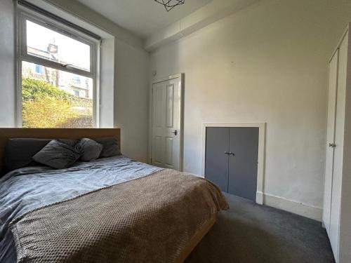 sypialnia z dużym łóżkiem i oknem w obiekcie Howburn Place w Aberdeen