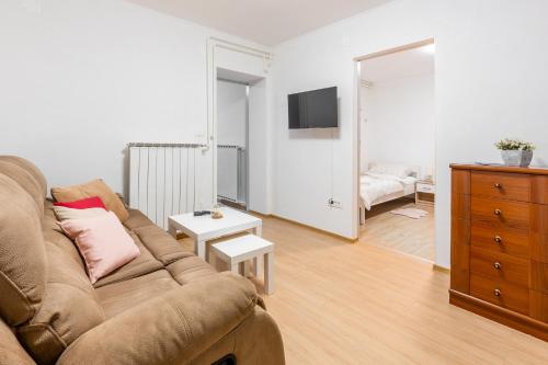 a living room with a couch and a bedroom at Apartma Lozar in Ajdovščina