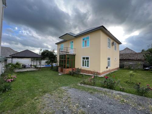 a large house with a yard with a yard at Villa at the center in Gabala