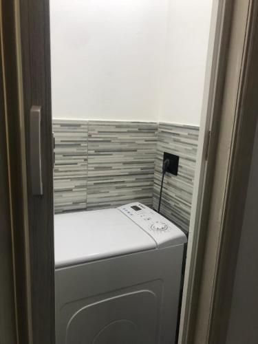a washer and dryer in a small room at Charming apartment in Ribera with mountain view – 40.2 m² in Ribera
