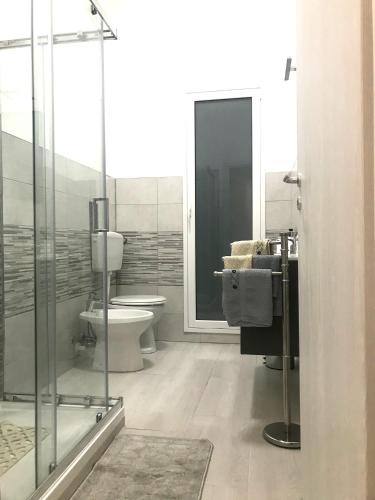 a bathroom with a glass shower and a toilet at Charming apartment in Ribera with mountain view – 40.2 m² in Ribera