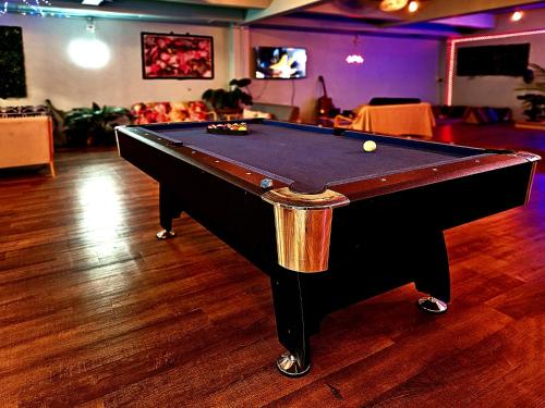 a pool table in a living room with at Tiki Tribe Bar & Hostel in Ko Tao