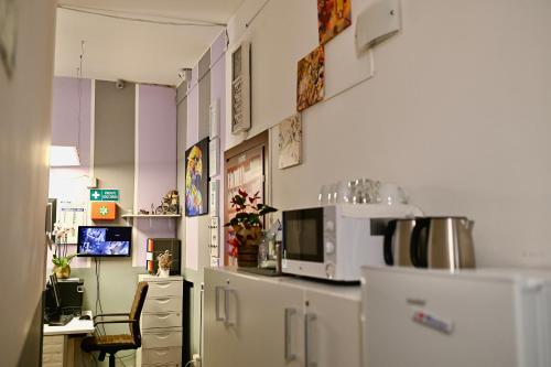 cocina con encimera, microondas y escritorio en Bovisa House B&B private rooms, en Milán