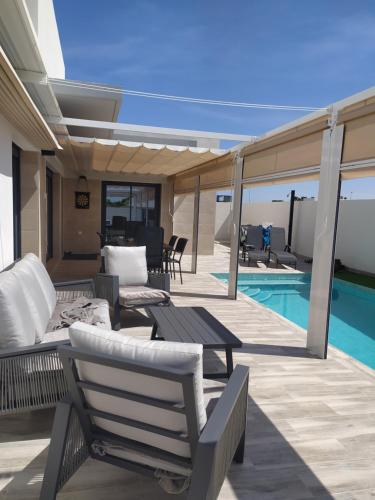 a patio with lounge chairs and a swimming pool at Casa XtelBen in Daya Nueva