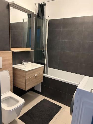 a bathroom with a toilet and a sink and a shower at Elegant Park Copou 2 rooms AB Homes in Iaşi