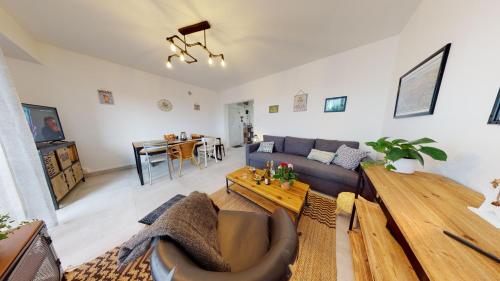 un salon avec un canapé et une table dans l'établissement Le Marcellin Colmar - Garage - Terrasse, à Colmar