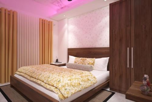 Hotel Aradhya Puri Sea View Room - Luxury Stay - Best Hotel in Puri في بوري: غرفة نوم بسرير كبير وسقف ارجواني
