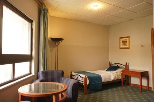 Un pat sau paturi într-o cameră la Conord Hotel - "Amman's Heart"