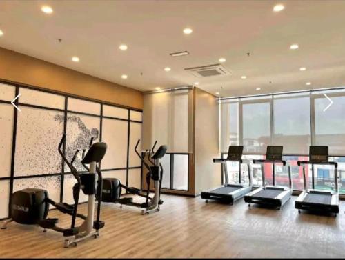 a gym with treadmills and cardio equipment in a building at Sky Tree Studio Apartment at Bukit Indah, Johor in Johor Bahru