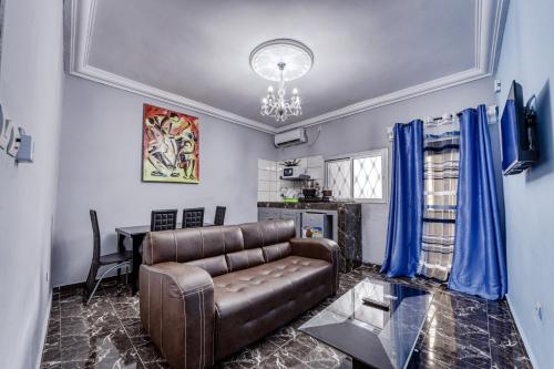 a living room with a couch and a table at CAMERHOME "Low Cost" in Douala