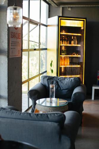 a room with couches and a table and a refrigerator at Quonset Glamping in Seferihisar