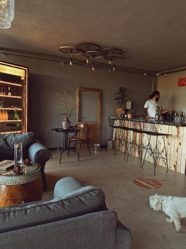 a living room with a man standing at a bar at Quonset Glamping in Seferihisar
